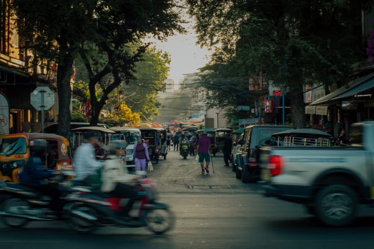 busy street in phnom penh cambodia with tuk tuks motorbikes and pedestrians during golden hour capturing daily life